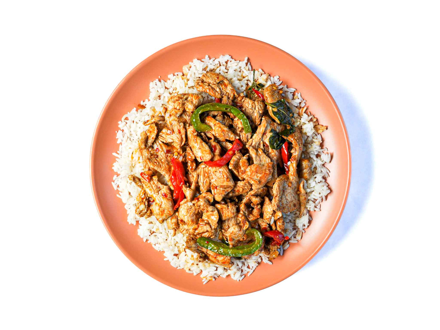 Coup de Thai's Pad Grr Pao features a stir-fry of fresh basil and tender meat, all coated in a spicy chili garlic sauce. This dish offers a perfect blend of aromatic herbs and fiery flavors, creating a delicious and authentic Thai meal.