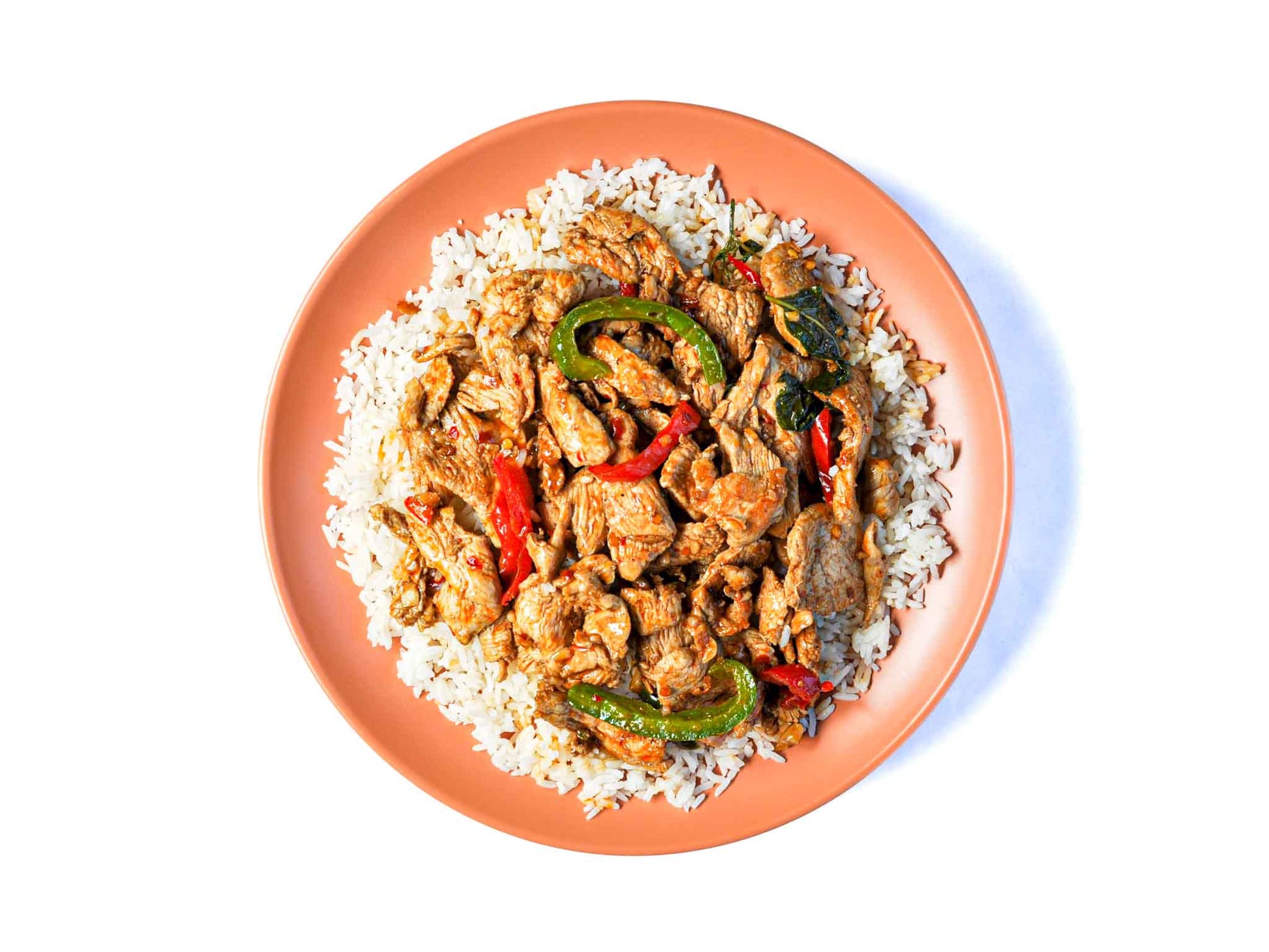 Coup de Thai's Pad Grr Pao features a stir-fry of fresh basil and tender meat, all coated in a spicy chili garlic sauce. This dish offers a perfect blend of aromatic herbs and fiery flavors, creating a delicious and authentic Thai meal.