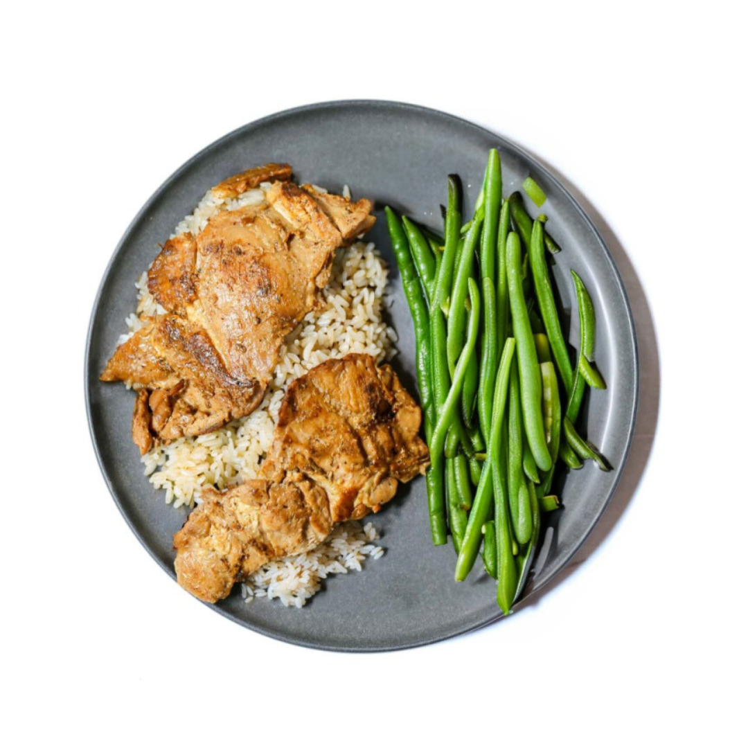 Hawaiian Drive Inn's Teriyaki Chicken features grilled boneless chicken marinated in their special teriyaki sauce. It comes with a side of white rice and steamed green beans, making for a balanced meal.