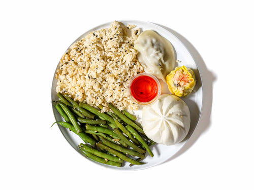 Koi Palace's Dim Sum Sampler Box features a delicious variety of dim sum, including one Peking dumpling, one siu mai, and one steamed BBQ pork bun, served alongside aromatic ginger fried rice and hoisin-glazed green beans. This dish offers a delightful combination of savory, sweet, and tangy flavors, perfect for a well-rounded and satisfying meal.