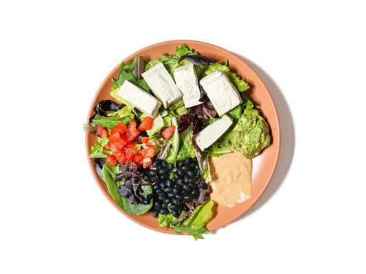 Ladle & Leaf's Tofu Chipotle Salad features flavorful tofu tossed with fresh black beans, juicy tomatoes, and creamy avocado. This dish offers a vibrant blend of smoky chipotle, earthy beans, and refreshing vegetables, making for a delicious and satisfying salad.