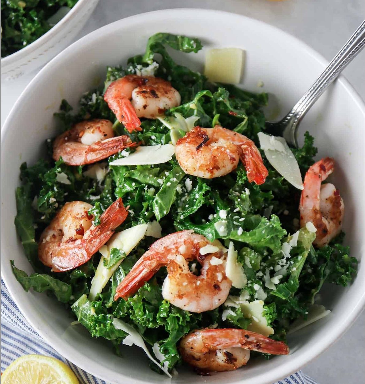 Tenderleaf's Nutritional Yeast Shrimp Caesar Salad features a vibrant blend of crispy romaine, tender kale, and perfectly grilled shrimp. Topped with crispy chickpeas and a generous sprinkle of savory nutritional yeast, this salad delivers a rich, umami-packed twist on the classic Caesar.