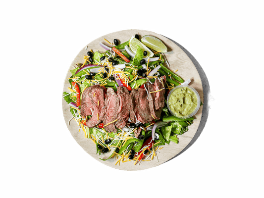 Perfectly seasoned steak strips atop a bed of fresh greens, complemented by zesty pico de gallo and creamy avocado tomatillo salsa. This flavorful dish delivers a vibrant Tex-Mex twist, perfect for a wholesome and delicious meal.