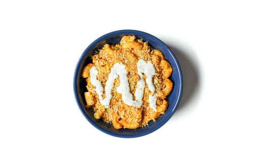 Homeroom's Buffalo Chicken Mac features tender buffalo chicken tossed in a creamy blend of cheddar and jack cheeses, topped with a drizzle of tangy ranch. This dish delivers a perfect balance of spicy, creamy, and savory flavors, making it a bold and satisfying comfort food favorite.