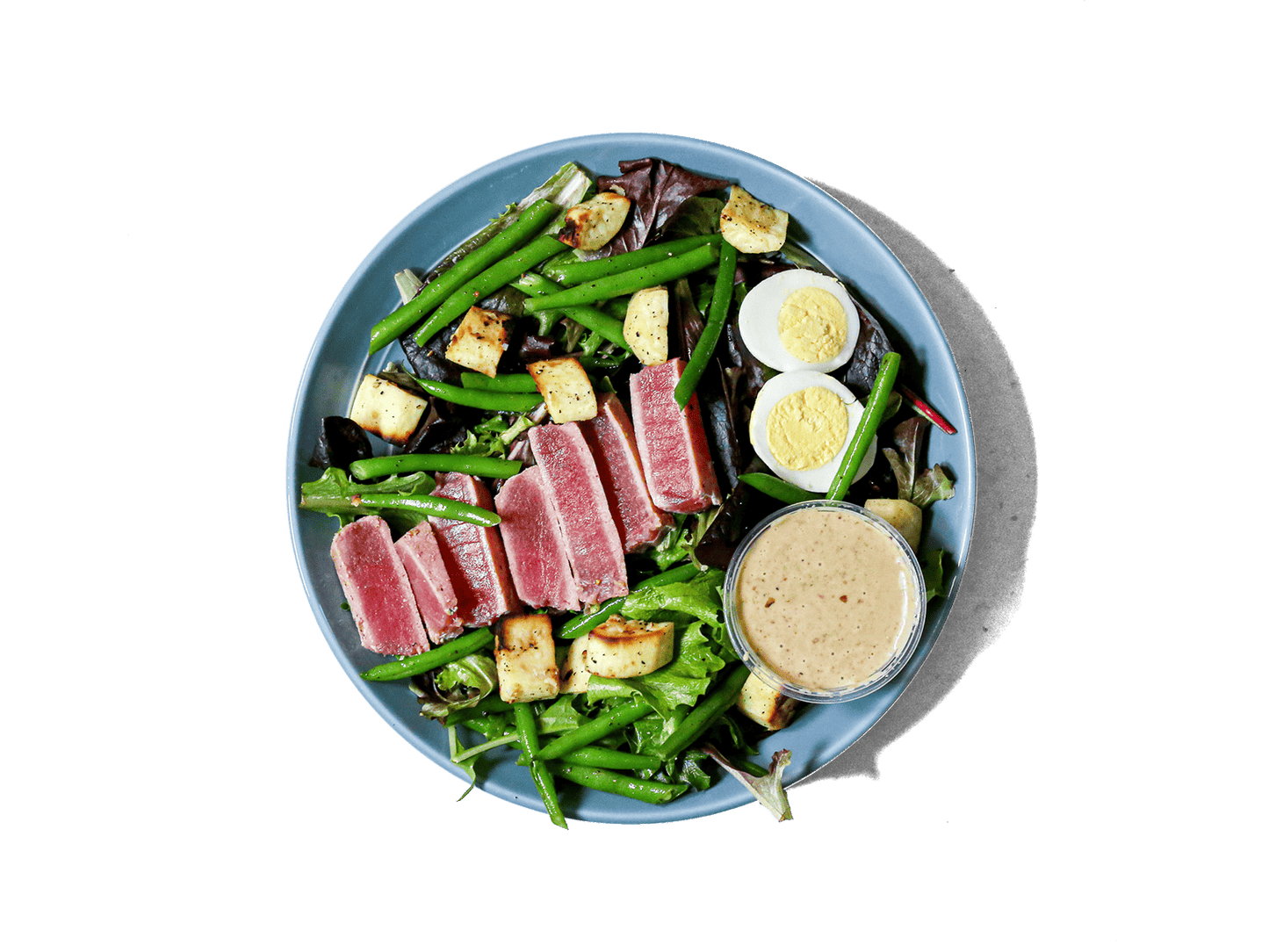 Delicate ahi tuna perfectly seared and served rare, atop a medley of organic greens. This elegant dish combines fresh, wholesome ingredients for a light yet satisfying meal.r