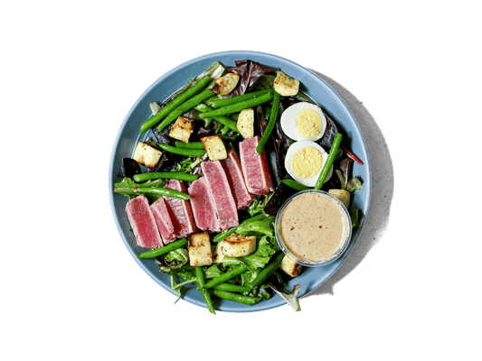 Delicate ahi tuna perfectly seared and served rare, atop a medley of organic greens. This elegant dish combines fresh, wholesome ingredients for a light yet satisfying meal.