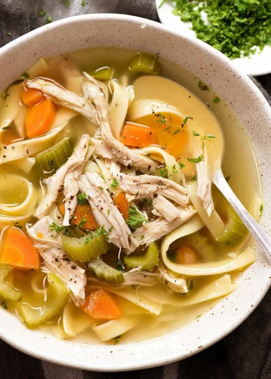 Ladle & Leaf's Grandma Mary’s Chicken Soup is a comforting classic featuring tender chicken and hearty egg noodles in a flavorful, savory broth. This warm and wholesome dish evokes the nostalgic taste of homemade goodness, perfect for a cozy and satisfying meal.