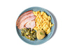 Heritage Berkshire Pork's Ham Plate features tender, smoky slices of premium ham paired with rich, buttery mac and cheese, hearty collard greens, and a slice of golden, crumbly cornbread. This Southern-inspired meal offers a comforting medley of flavors and textures, perfect for any comfort food lover.