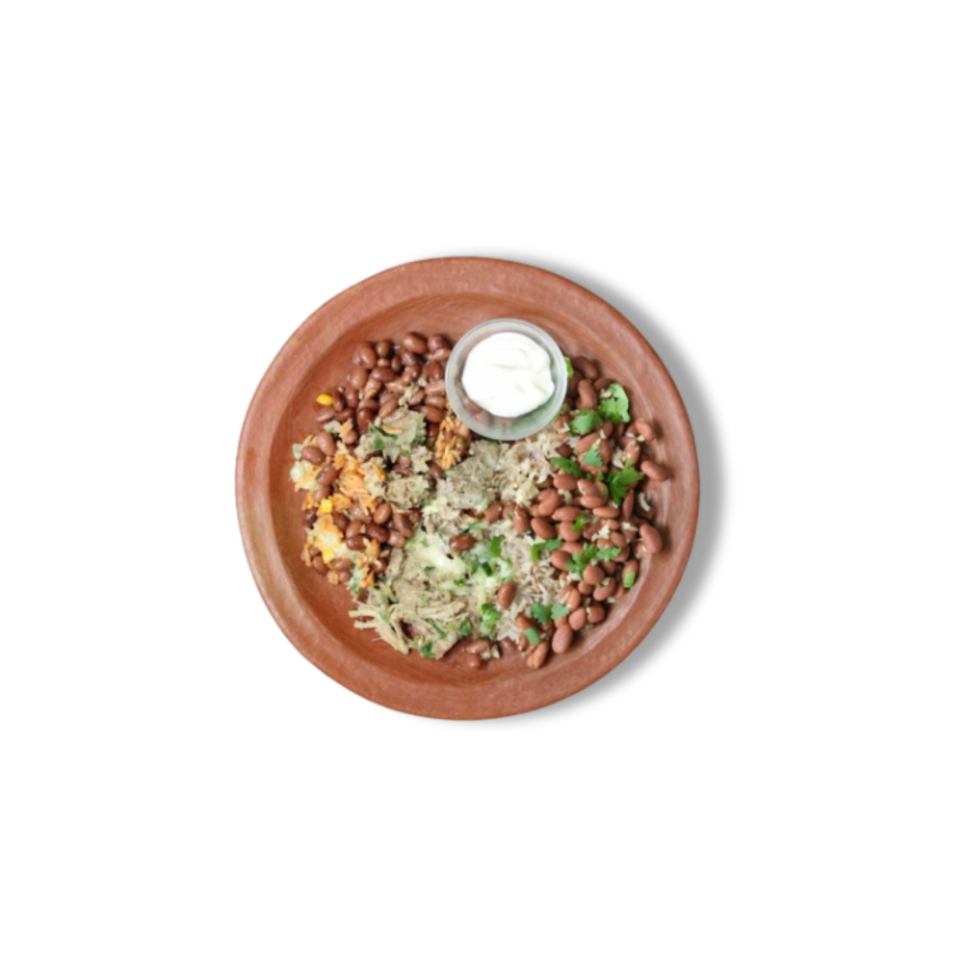 Comal's Carnitas Lettuce Bowl: Featuring Duroc pork carnitas, pinquito refried beans, red rice, cheese, crema, salsa verde, onion, and cilantro. A tasty blend of savory and fresh flavors.