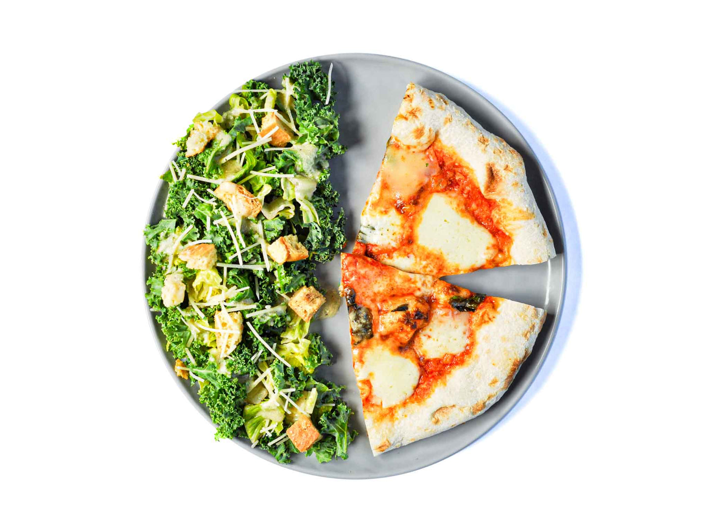 Pizzeria Delfina's 4 Formaggi Pizza features a blend of four delicious cheeses on a perfectly baked crust, paired with a fresh kale salad. This dish offers a rich, cheesy delight balanced by the crisp, refreshing flavors of the salad for a satisfying meal.