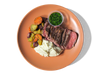 Tender, juicy steak served alongside heirloom marble potatoes. Accompanied by roasted carrots, and a fresh chimichurri, this hearty dish delivers bold flavors and a perfect balance of rich, savory notes and vibrant herbal freshness.