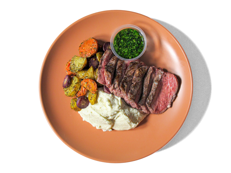 Tender, juicy steak served alongside heirloom marble potatoes. Accompanied by roasted carrots, and a fresh chimichurri, this hearty dish delivers bold flavors and a perfect balance of rich, savory notes and vibrant herbal freshness.