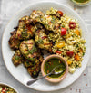 Tenderleaf's Pearl Couscous Chimichurri Chicken Bowl showcases tender chimichurri-marinated chicken atop fluffy pearl couscous, complemented by a bright lemon oregano dressing and crispy pita chips. This bowl is a vibrant mix of fresh, zesty flavors and satisfying textures for a wholesome meal.